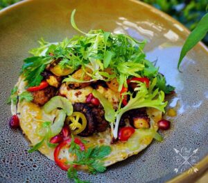 Lawrence Duran Instagram - Charred octopus/ Baby yukon/ Chorizo/ Tomatillo salsa/ Pickled peppers/ Celery/ Frisée/ Parsley/ Pomegranate/ Micro coriander .
.
.
.
.
.
.
.
.
.
 #Tostada #PicOfTheDay #SundayFunday #FoodPorn #Tacos #FitFam #FitFoodie #IGDaily #InstaFood #Chef #PrivateChef #WahlbergChef #Blessed