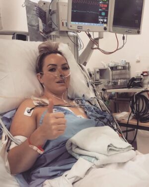 Leigh Holland-Keen Instagram - 3 weeks ago I underwent some pretty brutal surgery, surgery that I knew was risky but had to be done. I went to sleep after being told they would have to remove my left kidney, spleen, left ovary, part of my bowel, the 1kg liposarcoma and I'd have a "chemo washout" . I was so scared. It is so daunting being on your own and being faced with this. I also had an epidural prior to being sedated which brought back horrible memories of my birth but the team made me as comfortable as possible and gave me alot of reassurance which helped me in so many ways. 
.
.
I was extubated early as the surgery went well and I'm "fit and healthy" , the tumor was removed much easier than anticipated and they managed to keep the majority of my organs. I woke up with drips and drains coming out of everywhere - Arterial lines, central line, indwelling catheter, 2 abdominal drains, nasogastric tube, 3 intravenous cannulas, TPN, epidural infusion, and an oxycodone PCA. 
.
.
The next day, I had a cardiac arrest requiring CPR - I came round to a busy room full of medical staff racing around, working hard. I was told I would need a temporary pacing wire and the possibility of a pacemaker being inserted. After discussions with the cardiologist- they wanted to monitor me but attached to the defibrillator, an echocardiogram showed I have a bicuspid aortic valve with regurgitation (something I wasn't aware of). 
.
.
After 5 or 6 days in ICU I was finally moved to the ward - a few days in I developed an acute onset of new pain - I'd rather have back to back births than this pain again - I had an urgent CT at midnight to show I had pancreatitis. I was started on a continuous ketamine infusion which unfortunately made me hallucinate and I became agitated - that was stopped within 24hrs. After a couple of days things started to settle. Day by day, more drips and drains were being removed. I was in bed for 12 days so mobilising feels very weird and wobbly. 
.
.
This has certainly changed me - physically and mentally. I'll grow from this, I know it - but first I need to focus on getting my independence back and allowing myself to heal.