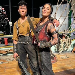 Madeleine Sami Instagram - More #ofmd2 bts shenanigans for anyone inclined 🏴‍☠️ 🖤 special shout out to @coramont and @teneseejade for painstakingly removing Archie’s tattoos with coconut oil every night and graciously putting up with the inevitable muscle show hahahaha 💪🏾 😂