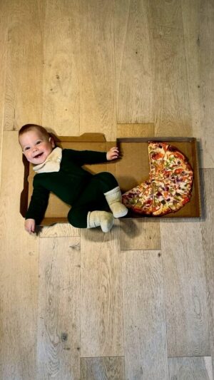 Maksim Chmerkovskiy Instagram - 🎉🎉🎉Our baby boy is 1 🎉🎉🎉

@rio.john.chmerkovskiy you light up our lives. 
You bring so much joy into our family.
We love you beyond 💙🍕

This pizza challenge we committed to so we could look back and have this forever. The last 2 months were tough haha because he was so aware of what was going on and did NOT want to be placed on the ground beside a pizza lol…