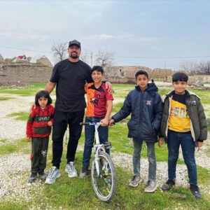 Manu Bennett Instagram - Kids out playing in the city of Harran on the Turkish/Syrian border. Originally a Sumerian trading centre Harran became one of the major stops along the Silk Road, being the first entry point into ancient Mesopotamia. Known to have existed long before 2000bc was Harrad’s famous temple Ekhulkhul (Temple of rejoicing) dedicated to Nanna the moon-god & his son Nusku god of light. After the Christian led destruction of Alexandria, Harran offered help to all refugees fleeing Roman persecution. The city went through many ruling transitions including Babylonian, Assyrian, Archaemenid, Macedonian, Seleucid, Roman & Parthian. It's importance as a trade & religious centre was surpassed by few other cities of the time but a violent occupation by the Mongols in 1260 led to the citys completely destruction in 1271 & the massacre of all its inhabitants. These children I'm standing with are refugees from the war in Syria, Allepo only a two hour drive across the border from Harran. #history #trade #war #refugees #religion #harran #turkey