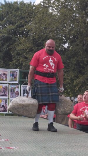 Martins Licis Instagram - WOW I got to witness @biglozwsm breaking his old world record Dinnie Stones walk of (332kg 730lbs total) for an amazing 22 ft 4 in, surpassing his old record of 14 ft 10 in! Simply majestic to watch! This feat is much harder than it looks, as the stones are not of equal weight, are an awkward clumsy shape and size, and the handgrips are thin rings that rip at one’s fingers. Huge congratulations Big Loz! Always strong 💪