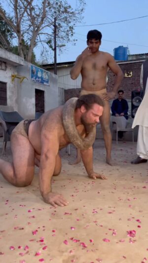 Martins Licis Instagram - This is called “Iron Ring,” it’s used as an accessory for traditional mud wrestling to strengthen the neck. The ring weighs 100 kg (220 lbs). Within a few repetitions, at this weight, the traps, upper back, and neck muscles immediately tense up. Finishing just one set, I felt a pump in my neck like never before. . . Could this be a future strongman event? 😈 … and a huge thank you to my new friend and Pakistani wrestling legend @tayyabwrestler_97 for showing me your ways 💪 #strengthunknown #pakistan