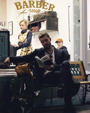 Marwan Berreni Instagram - Taking a break. 📖✨
Credit : @alexfaraut 
#reading #ofmiceandmen #steinbeck #book #barbershop #barber @harrods #harrods
