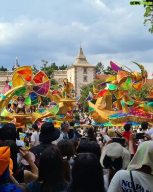 Matthew Okine Instagram - Spent the day at Tokyo Disneyland. Can't believe someone decided to "remake" this place 😂...

1. A sweaty old man (me) carries his daughter on his aching shoulders as she refuses to look at the camera.
2. Belinda, wearing red Minnie Mouse ears, tries to cool down using a portable fan and eating a mickey-mouse shaped strawberry ice block.
3. The "Go Coaster". Sofia's first rollercoaster. She loved it. We ended up going on it four times.
4.the view of Splash Mountain from the Rocky Mountain rollercoaster. Splash Mountain was a superior ride FYI.
5. A gourmet meal of soft drink, fries, and a sausage on a bone. There was also two mickey-mouse shaped pizzas hidden somewhere in this mix. They had corn on them though 😐
6. Mickey Mouse leads the most colourful float in the parade.