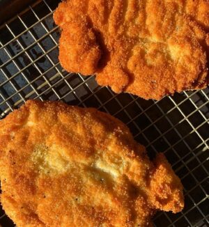 Megan Mitchell Instagram - Crispy chicken cutlets with an arugula, apple, walnut and fennel salad👇🏼⁣
⁣
Ingredients:⁣
• Canola oil, for a shallow fry⁣
• 2 8-ounce boneless, skinless chicken breasts⁣
• 1/4 cup AP flour⁣
• 1 egg⁣
• 3/4 cup plain breadcrumbs⁣
• 1 tsp. kosher salt, divided⁣
• 1 tsp. freshly cracked black pepper, divided⁣
• 1/4 tsp. garlic powder⁣
FOR THE SALAD:⁣
• 3 tbsp. extra virgin olive oil⁣
• 2 tbsp. apple cider vinegar⁣
• 1 tbsp. whole grain mustard⁣
• 2 tsp. dijon⁣
• 2 tsp. maple syrup⁣
• Kosher salt, to taste⁣
• Freshly cracked black pepper, to taste⁣
• 1 small head fennel, cut in half lengthwise and then thinly sliced into half-moons, fronds reserved⁣
• 1/2 granny smith apple, cut into thin half-moon slices⁣
• 2 lightly packed cups baby arugula⁣
• 1/2 cup chopped walnuts, toasted⁣
⁣
Directions: ⁣
• Fill a 14-inch cast iron skillet halfway with oil. Bring up to heat over medium to 350F⁣
• Place 1 breast at a time into a gallon sized resealable bag. Using a rolling pin or the flat side of a meat tenderizer, evenly pound out the breast to 1/4-inch thick. Remove and continue with the 2nd breast. Remove⁣
• To the same bag add 1/2 tsp. of salt and 1/2 tsp. pepper along with the flour and shake⁣
• Add 1 breast at a time and shake to coat⁣
• In a medium shallow bowl crack the egg and beat. To another medium shallow bowl add the breadcrumbs, 1/2 tsp. salt, 1/2 tsp. pepper and garlic powder. Mix⁣
• Take the floured breasts, one at a time, and place in the egg, coating both sides and then place into the breadcrumbs, pressing the mixture in. Place back onto the plate and continue with the other breast⁣
• Carefully add both chicken breasts to the skillet and cook 2-3 minutes per side until golden brown and crispy. Remove to a sheet tray lined with a cooling rack and keep warm in a low oven while you make the salad⁣
• To a large bowl add the EVOO, vinegar, whole grain mustard, dijon, maple syrup and a large pinch of salt and pepper. Whisk together then add in the sliced fennel, apple, arugula and walnuts. Toss and taste for seasoning⁣
• To serve plate the chicken cutlet with some of the salad and garnish with the reserved fennel fronds