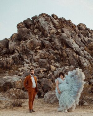 Melanie Field Instagram - #OTMBride @melanie__field and Zachary Likins first matched on @bumble. 🐝 A year and four months later, he proposed while on a trip to see her family in Philadelphia. 💍 Once engaged, the couple agreed they wanted to share their love of the desert 🏜️ with their friends and family and get married in Joshua Tree. 
⠀⠀⠀⠀⠀⠀⠀⠀⠀
For the ceremony, Mel aimed to wear something unique. “I wanted to look and feel regal like a princess but from another universe,” the bride says of her wedding dress vision.🪐🛸💙👑 “And I knew I wanted tulle and lots of it, so I could just plop down on the ground in a pile of tulle. 
⠀⠀⠀⠀⠀⠀⠀⠀⠀
The bride found @millia.London and the label’s designer, Ruth, made her dream come to fruition. “As a plus size woman, I’ve spent most of my life feeling very excluded from high fashion. My experience with Millia London was not only lovely but healing in many ways,” Mel shares. “I didn’t have to settle on my special day, and I one-hundred percent felt like the wormhole space princess who fell from the sky—just like I dreamed I would.” 👰🏻‍♀️

#OTMWeddings #OTMExclusive #DesertWedding #CaliforniaWedding
⠀⠀⠀⠀⠀⠀⠀⠀⠀
📷: @wearemattandjess
Planning: @yuandus
Beauty: @angiebulmer @dear_shears
💐: @desertrose.creative
Catering: @mojavedesertcharcuteriecompany @sohotaco
🎶: @whosjondoe
🍰: @picnicbakedgoods