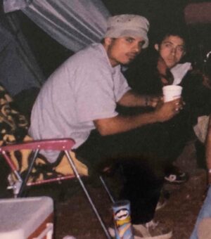 Michael Peña Instagram - Damn why am I so serious about my cup o noodle around a camp fire? I had Pringles for good measure. Thanks for the pic @thenaterichert circa 2000s at a bluegrass festival!!!