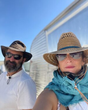 Michaela Watkins Instagram - Just got back from @burningman. Haven’t caught up with what Chris Rock said- and I don’t care. Why? Because as it was suggested by a good friend, taking pot shots and men of color for joking wanting a coffee or something is pretty lame. Let’s not even go there, folks. Let’s just not. 

As far as @burningman, we had a damn blast and I honestly don’t know why we made any headlines. The actual headline should’ve said “it rained at burning man and it made it hard to ride a bike for a day”. Yes I’m being cheeky here, but I do wish the community care and kindness and humanity that kept everyone rolling and their spirits up translated to our real world. These 80k people are resilient as hell. My fav is watching people slipping around in the mud as they went to check on others while laughing their ass off. No this was not fyre fest. It was a community of capable loving folks with way too much shit making sure everyone was all set for the day. 

Just like the real world, BM is an amalgamation of the best and ugly things humans have to offer. Much I could do without but some of it makes this place truly the most mystifying thing I’ve seen. Holding both at the same time is the struggle. 

Anyway, here are some pics of us being accidentally adorable. More to come when I upload my husbands phone at some point this year…