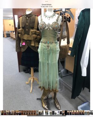 Michele Clapton Instagram - The Kings Men costumes. Here are some illustrations and fittings for Mata Hari.. A little artistic license taken with her costumes here but we based the looks on shapes that in research we noted that she wore. I loved this dark green fabrics sheen, it had depth and weight and a drape that is often missing in cotton satin. It was similar to the wonderful Glendina from Whaleys ltd.. my go to fabric of choice!!..We knew it would light well in low light which we anticipated would often be the case for her scenes in the script. I felt that it still needed a detail of extra texture so we stitched parallel lines following the shape of the collar and pocket flaps. We also had made some beautiful two tone button boots which I can’t find a photo of but these are the shoes we designed for another of her looks.. Valerie Pachner the actress was so lovely to collaborate with and endlessly patient. We had to create this jewelled and metal Mata Hari performance piece that she had to dance in for the American President. Although we don’t see much of this costume or performance in the way the scene was shot ( we were a little heart broken) Valerie was incredible as were all of the costume team involved.