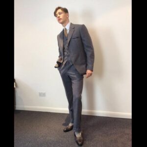 Michele Clapton Instagram - Conrad suits.  Ok you might be bored of me showing these costumes by now.. but if you are then look away! I just love to go back and remember/enjoy our work, as it’s sometimes so hard to do so in the thick of filming. These are fitting photos so the costumes are unfinished.
We loved our fittings with Harris Dickinson who played Conrad. It’s often difficult for younger actors used to wearing sports wear to feel comfortable in period cut clothes, especially the stiff high collars, so we spend time in fittings with the choreography of a costume, how it makes you walk and stand.. it’s a real aid. Harris bought so much to this role and ended up loving this style…he really made the costumes his own and we loved that his body shape was so good for the period cut.. the modern muscular shoulders and arms are more difficult to accommodate in these narrow suits.. Matthew Vaughn the director is obsessed by the cut and fall of mens suits so he really kept us on our toes. We made some suits in our work room cut by the wonderful Tim Perkins and others were made by the incredible Campbell and his team at Huntsman. The final suit here was one of my favourites and much lighter weight, it was the most unusual, quite American in cut, I liked it for the scene in Sarajevo. It was really difficult fabric to work with and we had to make multiples for the stunt scene.. Campbell was not impressed! But it turned out great! Shoes by George Cleverley complete the looks and glasses made to our design by Cuttler and Gross. Klaire Jamin on buying duty again killed it..along with assistant designers Alex Fordham,
Sophie O’Neill, Emma O’Loughlin, illustrator Simon Thorpe 
@huntsmansavilerow @timjohnperkins @sim0ndo @cutlerandgross @georgecleverley