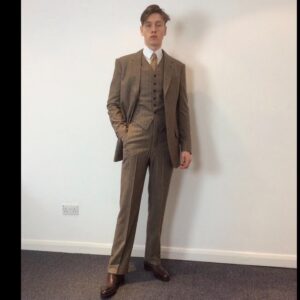 Michele Clapton Instagram - Conrad suits.  Ok you might be bored of me showing these costumes by now.. but if you are then look away! I just love to go back and remember/enjoy our work, as it’s sometimes so hard to do so in the thick of filming. These are fitting photos so the costumes are unfinished.
We loved our fittings with Harris Dickinson who played Conrad. It’s often difficult for younger actors used to wearing sports wear to feel comfortable in period cut clothes, especially the stiff high collars, so we spend time in fittings with the choreography of a costume, how it makes you walk and stand.. it’s a real aid. Harris bought so much to this role and ended up loving this style…he really made the costumes his own and we loved that his body shape was so good for the period cut.. the modern muscular shoulders and arms are more difficult to accommodate in these narrow suits.. Matthew Vaughn the director is obsessed by the cut and fall of mens suits so he really kept us on our toes. We made some suits in our work room cut by the wonderful Tim Perkins and others were made by the incredible Campbell and his team at Huntsman. The final suit here was one of my favourites and much lighter weight, it was the most unusual, quite American in cut, I liked it for the scene in Sarajevo. It was really difficult fabric to work with and we had to make multiples for the stunt scene.. Campbell was not impressed! But it turned out great! Shoes by George Cleverley complete the looks and glasses made to our design by Cuttler and Gross. Klaire Jamin on buying duty again killed it..along with assistant designers Alex Fordham,
Sophie O’Neill, Emma O’Loughlin, illustrator Simon Thorpe 
@huntsmansavilerow @timjohnperkins @sim0ndo @cutlerandgross @georgecleverley