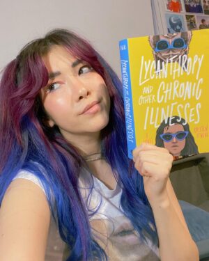 Michelle Grondine Instagram - when you match your reading material 👀💙 

i’m a little behind on my tbr rn but i just started this Teen Wolf meets Emergency Contact vibes story, LYCANTHROPY AND OTHER CHRONIC ILLNESSES by Kristen O’Neal, starring a main character, Priya, a premed student diagnosed with chronic lyme disease, who embarks on a road trip to find her online friend Brigid IRL when Brigid stops virtually showing up to their regular Discord chronic illness support group, only to find an unexpected surprise awaiting for her at her destination. 

in their author note, O’Neal writes: “I wrote it for everyone who felt the loneliness, isolation, and invisibility that comes with being young and being sick.” living with chronic pain myself, that made me even more intrigued to embark on this journey with Priya, Brigid, and their Discord server support group. in this panna cotta, my biggest sources of support have come from the Discord servers I am a part of, so—HEAVY RELATE. hooray for found family!

Q: what are some outlets, hobbies, or things that helped you cope through challenging times?

thanks again to @quirkbooks for sending me this finished copy, along with the following amazing character playlist for Brigid, which I plan to listen to while I read this:

♡︎Brigid’s Playlist♥︎
1. Philosophize In It! Chemicalize With It! — Kishi Bashi
2. Looking Like You Just Woke Up — The Front Bottoms
3. Head Is a Flame (Cool With It) — Portugal. The Man
4. I Wanna Get Better — Bleachers
5. The Ice of Boston — Dismemberment Plan
6. Mouth of the Cave — Typhoon 
7. Complicated Creation — Cloud Cult
8. Semi-Automatic — Twenty One Pilots
9. The Sickness Unto Death — Typhoon
10. Artificial Light — Typhoon
11. If You Want Blood (You’ve Got It) — AC/DC
12. Sleep Forever — Portugal. The Man

for the full playlist, visit: bit.ly/brigidsplaylist 🎶 have a great rest of your wednesday !!! 𓆉