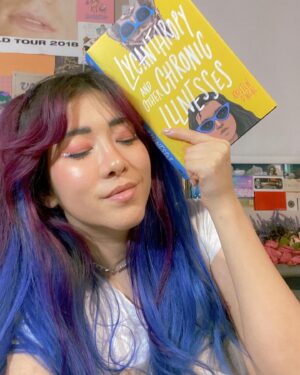 Michelle Grondine Instagram - when you match your reading material 👀💙 

i’m a little behind on my tbr rn but i just started this Teen Wolf meets Emergency Contact vibes story, LYCANTHROPY AND OTHER CHRONIC ILLNESSES by Kristen O’Neal, starring a main character, Priya, a premed student diagnosed with chronic lyme disease, who embarks on a road trip to find her online friend Brigid IRL when Brigid stops virtually showing up to their regular Discord chronic illness support group, only to find an unexpected surprise awaiting for her at her destination. 

in their author note, O’Neal writes: “I wrote it for everyone who felt the loneliness, isolation, and invisibility that comes with being young and being sick.” living with chronic pain myself, that made me even more intrigued to embark on this journey with Priya, Brigid, and their Discord server support group. in this panna cotta, my biggest sources of support have come from the Discord servers I am a part of, so—HEAVY RELATE. hooray for found family!

Q: what are some outlets, hobbies, or things that helped you cope through challenging times?

thanks again to @quirkbooks for sending me this finished copy, along with the following amazing character playlist for Brigid, which I plan to listen to while I read this:

♡︎Brigid’s Playlist♥︎
1. Philosophize In It! Chemicalize With It! — Kishi Bashi
2. Looking Like You Just Woke Up — The Front Bottoms
3. Head Is a Flame (Cool With It) — Portugal. The Man
4. I Wanna Get Better — Bleachers
5. The Ice of Boston — Dismemberment Plan
6. Mouth of the Cave — Typhoon 
7. Complicated Creation — Cloud Cult
8. Semi-Automatic — Twenty One Pilots
9. The Sickness Unto Death — Typhoon
10. Artificial Light — Typhoon
11. If You Want Blood (You’ve Got It) — AC/DC
12. Sleep Forever — Portugal. The Man

for the full playlist, visit: bit.ly/brigidsplaylist 🎶 have a great rest of your wednesday !!! 𓆉
