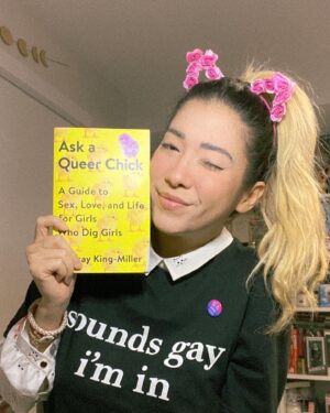 Michelle Grondine Instagram - a few september favorites:
- Ask A Queer Chick: A Guide to Sex, Love, and Life for Girls Who Dig Girls by Lindsay King-Miller @askaqueerchick,
- this ‘sounds gay i’m in’ shirt from @thtsoundsgay (use code travelingbooknerds to get 30% off your entire order). proceeds from @thtsoundsgay website sales are donated to youth GAS orgs and leaders across 🇺🇸 via @gsanetwork;
- freaking romance by @snailords on @webtoonofficial is a god-tier toon and zylith has given me the confidence to simply exist with cat ears at any time i desire (these are from @flowerchildrenonly). also every character is amazing and i ship both zylith   verose *and* zylith   the lavender scented ultra soft soft boy aka zelan;
- ‘bi-fi signal strong’ pin ‘cause puns 😆 (ps: happy bi  visibility month!);
- this collared crop top covered in kitten faces. (need i say more?);
- this eyeliner kitten wing that i somehow got evenly on the first try for both eyes that was some sort of magical manifestation come to life that i’m glad got documented for personal history purposes.
—————
q: what are some of your current obsessions?