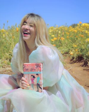 Michelle Grondine Instagram - aloha book nerds and pals 💞 your friend michelle here ✨ happy asian american pacific islander heritage month !!! ✨ this month, which is also my birth month & mental health awareness month, i will be doing my best to highlight & share some of my favorite books, films, and shows by my favorite asian & asian american creators! 

as you may or may not know, i was raised in tokyo, japan for most of my youth until i left home for college at 18. i studied japanese literature in HS, & grew up religiously reading manga. one of my goals i set for myself 2 yrs ago was to start reading japanese texts in both its original japanese as well as its translated english to get a feel for japanese stories & translations better, & see how a story exists in multiple languages. i hope to be able to continue on my journey this month, & through sharing my experiences, maybe inspire others to pick up some books by japanese authors, as well as other asian & asian american authors.

one of my favorite asian american authors is @sarahkuhnbooks. her novel I Love You So Mochi is such a heart-filling comfort read, & her Heroine Complex series is so fun & iconic—starring a biracial japanese personal assistant to a female superhero who is her childhood friend. Kuhn’s newest book, FROM LITTLE TOKYO, WITH LOVE, comes out May 11, 2021 from @penguinteen. i love that this book stars a “biracial girl with formidable judo skills & a fiery temper” who “knows she’s the least princess-like person in all of LA.” then, when a series of tantalizing clues start pointing to Rika’s mom being alive *&* a huge Hollywood movie star, it’s the start of a madcap quest—complete with the help of a dreamy sidekick in actor Hank Chen by her side. i’m quaking to find out what happens !!! i just know i’ll be experiencing the full range of emotions represented in the photo series above.

congratulations again to @sarahkuhnbooks & @penguinteen on this stunning release, i’m absolutely obsessed with the cover, & so excited by the existence of stories like this one. thank you for the dedication to the halfie club, & thank you for believing in our happily ever after.

Q: what’s an asian american book on your tbr this month?