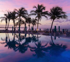 Mike Theiss Instagram - The tropical sunrises in Barbados are simply amazing ! We have been waking up to reflecting palm trees and beautiful purple skies every morning. It’s so peaceful to sit on the beach and watch as the sky changes colors during sunrise. It’s a perfect way to start the day !! Photo by Mike Theiss. #SandalsRoyalBarbados @SandalsResorts