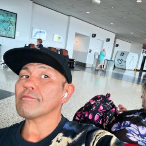 Minoru Suzuki Instagram - Delay

昨日飛行機に乗るハズだったんだけど…スコールで飛行機がディレイ…それに乗ったとしても目的地までの最終飛行機に乗れないらしい…翌日…要するに今朝の便に変更してもらい目的地へ行くことに…昨夜は空港内の直結するホテルへ…早朝にGATEへ向かう…またまたディレイ(笑)…おいおいおいおいおいおいおい！…やっぱり飛行機ちょっと遅れるけど飛びまーす…とアナウンス…客の大歓声と拍手…さすがアメリカ🇺🇸…飛行機に乗る…乗継の空港に到着したらオレが乗るハズだった飛行機はとっくに飛んでた(笑)…飛行機テェンジしようとカスタマーセンターと書いてあるところへ向かう…ん？無いぞ？…さっきのところに戻ってきて表示を確認…ん？？？無いぞ？カスタマーセンター！…2〜3度歩いて気がついた…もしかしてここにある機械で勝手にやってくれってことか？…チェックイン機みたいのが並んでたのでチケットを読み取らせたら「あなたの予定は飛行機が遅れています。この便に乗り換えますか？」…おおお！便利！…んで、飛行機を次の便へ差し替えていま昼メシのサンドイッチ食べながら飛行機待ち…。。なかなかの珍道中ぶりだろ？独り旅にトラブルはオプションです。こんな時だから笑っていきたいもんだ。。。しかし…そもそも試合に間に合うのか？？　ワハハハハハ〜