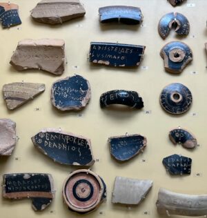 Natalie Haynes Instagram - Election day! At least, it is where I live.
And an opportunity to remember that people haven’t always voted FOR politicians; in 5th century BCE Athens, men (citizenship was restricted to adult male Athenians), could also vote AGAINST politicians or other noteworthy people. So if someone annoyed you, you could scratch his name onto a sherd of pottery (the Greek word for this is ostrakon - which is where our word ostracism comes from), and whoever got the most votes could be booted out of Athens for 10 years. There were some safeguards - a quorum of 6000 voters had to be present. 
But the system was set up to prevent demagoguery - as a general rule, anyone who has a high enough profile to affect democractic votes will also antagonise enough people to be at risk of ostracism. So unless your policies had a good impact quickly, you might be out on your ear. 
Here we can see lots of ostraka with names scratched on: Themistocles, Aristeides, Hippocrates and more.
I often find myself thinking that ostracism would be a good custom to revive, since it would really separate the popular politician from the ones who just shout culture war slogans. 
Happy voting!