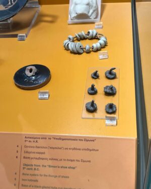 Natalie Haynes Instagram - It is so rare for us to know the name of an ordinary person who had an ordinary job in antiquity - we tend to know far more about leaders, statesmen, warriors, orators etc. But look at this - from the Athenian Agora Museum. You can see a set of hobnails, for boots. And a set of bone eyelets, for the leather thongs that tie your shoes in place. And there is also the base of a broken cup that tells us the name of the cobbler who used these items: Simonos. So, these objects belonged to Simon the shoe-maker. Isn’t that terrific?