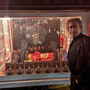 Neil Gaiman Instagram - I popped into The Golden Notebook, my local bookshop, to sign a thousand books or thereabouts. On the way out I saw this, their Holiday window, highlighting What You Need To Be Warm. It warmed my heart. (It's a picture book of a poem, and all the proceeds go to helping keep Refugees warm...)