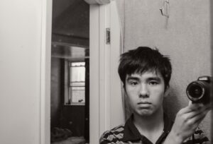 Ocean Vuong Instagram - Self-portrait on 18th birthday with borrowed Nikon, 2006.

Strange how I often glimpse a hidden, residual sadness in photographs once they cross the threshold of a decade from being taken. Could it be that distance itself creates a kind of longing, not to live again the years, however painful or joyous, but to do them in another way? Just once?

Here I am, hair cut by my mom, no poems written yet, with a camera lent to me by a friend to document his punk band that played in Connecticut basements. Why I was compelled to take this, I don’t know. Was I ever myself or merely a matrix of occurrences in one moment, and then yet another the next? Anyway, I want to hug you, wordless, younger Ocean, and I want it to mean nothing. Nothing at all.