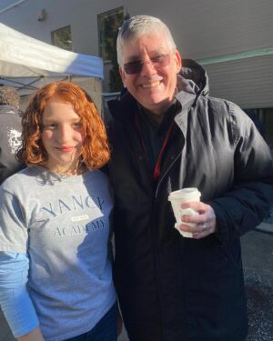 Olivea Morton Instagram - Here is the picture of myself and Uncle Rick that I mentioned in the interview with #EntertainmentRoadmap.  There is also a rehearsal for the fountain stunt where Cassandra is standing in for Walker.  It was my first wirework experience, and now I know how it feels I really want to do more stunts!

The entire crew made sure we were all safe and comfortable at all times.  I had a wetsuit on underneath my wardrobe, and was given all the hot tea, towels and blankets that I needed.  Even my trailer had a fireplace that kept everything nice and cozy!

I’m really happy that they decided to make Nancy and her friends pretty rather than how Percy describes us in the book, even though I was totally up for it!  But if you think about it, it’s written from a twelve year old boy’s perspective, and it makes sense.

Thank you to everyone who has watched the entire interview, I am a talker!  You have given me such wonderful compliments, and it means the world to me!  The entire time was a fantastical experience, one that I will cherish my entire life. 🔱🧡🩵

#rickriordan #nancybobofit #percyjacksonandtheolympians