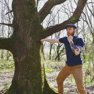 Oliver Claffey Instagram - After many months of shadow boxing, roadwork, and conditioning my knuckles with Trevor the Tree (pictured here) gyms are finally reopening! Things are starting to look up.

🐊🏴‍☠️

#captainjack #thenavigator #hipsterpirate #boxing #bareknuckleboxing #muaythai #mma  #gymlife #tattoos #southpaw