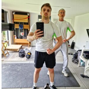 Parry Glasspool Instagram - When my Father wore the same workout top as me this morning, I knew instinctively that it was a poorly concealed attempt at a power move from the ageing patriarch. He knew his position as alpha of the family was at risk. I could've taken offensive to this move and submitted him with a simple triangle choke - ending this tired facade and forever changing the hierarchy of power in this house - But instead, I chose to respect it, learn from it, and bring in those gains together - passing of the torch, so to speak. 
But here's us flexing after a tough, life altering session.