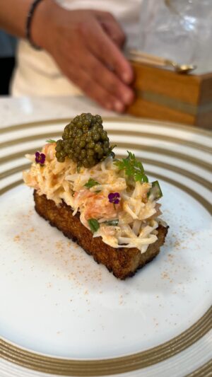 Paul Ainsworth Instagram - ‘Dreams of Crab Sandwiches’ 🦀

This dish was inspired by the humble crab sandwich, a staple in Cornwall and something I would hunt down when I first moved to Cornwall on a day off. I just love them! Even though they can be found everywhere, finding a good one can often be harder than you think. 

Here, we’ve reimagined this humble staple, using the most amazing Jack Crabs caught daily by @flyingfish525. We steam and pick these beauties, collecting every last piece of meat, before combining with a ponzu mayonnaise, pink grapefruit and fragrant herbs. 

The bread, a key part of this beautiful dish, comes from a homemade classic white bloomer, that we toast over the coals and glaze in a roasted tomato buerre noisette. Atop, we serve a generous helping of the crab, a little dusting of dehydrated brown crab meat and, to finish, some of N25’s Golden Oscierta caviar. ✨