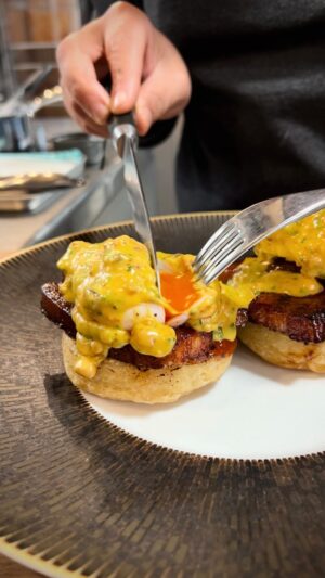 Paul Ainsworth Instagram - @HexClad_uk challenged me to level up one of my all-time favourite recipes, Eggs Benedict, so here’s my twist, with homemade crumpets, port glazed bacon, bacon-infused béarnaise, poached eggs and tarragon. #nevermadeitbefore 👊🏾🔥

Ingredients you need

Bacon
2 litres water
500 g piece smoked cured bacon belly (reserve trim for later)
1 onion Cut into ¼ 
1 leek cut into ¼ 
1 carrot cut in ½ 
3 celery stick cut in ¼ 
4 sprigs thyme
3 cloves garlic
2 cinnamon stick
2 star anise
10 black pepper corns

Bacon glaze
½ tbsp ground cinnamon
½ tbsp coriander seeds
2 star anise
1 tbsp vegetable oil
20 g port
20 g honey
20 g rice wine vinegar

Crumpets
150 g strong plain flour
½ tsp salt
½ tsp sugar
200 g water
2 tsp fresh yeast
1 tsp baking powder
3 tbsp vegetable oil
100g Bay tree spiced tomato and onion seed relish

Bacon Béarnaise sauce
100 g smoked streaky bacon, finely chopped
300 g unsalted butter, roughly diced
2 egg yolks
10 g white wine vinegar
1 tbsp warm water
1 tbsp Dijon mustard
3 g tarragon chopped fine
5 g chervil chopped fine
5 g chives chopped fine

Poached eggs
Water
2 tbsp malt vinegar
4 medium or large freshly laid eggs 
Seasalt
Cracked black pepper.