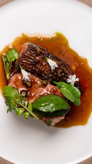 Paul Ainsworth Instagram - A dish that utilises some great Spring produce, alongside incredible grass-fed Moorland beef from @philipwarrenbutchers. 

We start, by roasting the fillet in a pan, caramelising it on all sides, before adding in a little butter, some rosemary, thyme and garlic. We then rest this over the coals until just blushing pink, before carving. All the trimmings from the chain of the fillet are roasted and this forms the base of our bordelaise-style sauce, spiced with Likouala Pepper - a perfect, rich, red wine and port sauce.

The morel, is roasted in the same pan of butter, garlic, rosemary and thyme, before being stuffed with a deeply-flavoured chicken mousse, laced with black winter truffle and roasted duck liver. The final touch, is the addition of fine green herbs, served in the style of a salsa verde, which is lightly chilled. ⁠

Voila; Fillet of Moorland Beef (Tallow aged) ~ Morel farcie ~ Likouala pepper