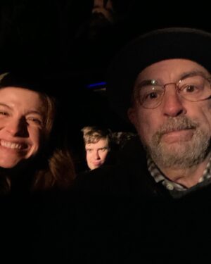 Richard Schiff Instagram - Are we- Trying to keep warm on late night shoot?  Or…on a road trip? Or… bars are closed so we’re drinking in a car? Voting is open.