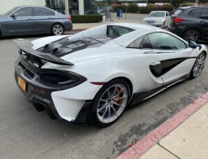 Rob Corddry Instagram - A McLaren 600LT loaner was dropped off on the set of The Unicorn over a year ago. My Top Gear America cohost Jethro Bovingdon used his ties at McLaren to throw me the bone, registering my frustration over having been on TGA for a month without being gifted that fabled “weekend loaner”. 
If you haven’t seen the Unicorn (shame on you—I guess you hate to laugh?) the cast aren’t exactly “McLaren Types”, excluding Omar Benson Miller who just smiled and nodded, knowingly. The others reacted like I had been delivered a space ship which it may as well have been.
I have only scribbled notes a year old to guide me (one reads “Ow”) but I remember dying for the shooting day to be over so I could blast up the 5 and slide into my driveway sideways with a sweet handbrake maneuver I can only execute in my imagination.
But it was not to be. No one blasts up the 5 at 6pm. Into my second hour of crawling I probably wrote “Ow”. The 600LT is the peak of McLaren’s Sport Series and a track focused car with fixed racing seats. Perfect for canyon carving, imperfect in a river of brake lights. I managed to have a ton of fun in this car though. Later that night, I drove my kids and friends around the block leaving them thinking, rightly, that I was Ironman. 
Day 2: Determined to make fire shoot out of its top exit… exhaust? Engine tubes? Fire-pipes? Who cares… short answer: this car spits fire. And on a canyon road there is nothing like punching the gas, waiting the glorious fraction of a second of lag before you feel the car sink down into the road and disappear with a whistle of turbo. The afternoon was literally a blur. A note written later reads only “handling!!!”. I’m a terrible note-taker. But nothing I’ve driven compares to the perfect balance this car achieves. I think I was referring to McLaren’s engineers when I wrote “Who the fuck are these people?!” 
The 600LT was my first supercar and I’m still thinking about it. I can’t imagine a car braking and steering with the ease of the 600LT. When I die, this will be the car that ruined cars for me, my constant refrain being “Awesome, but it’s no 600LT”