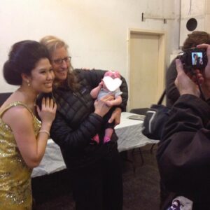 Ruthie Ann Miles Instagram - Part Five. 

When I was 2 weeks postpartum Clint called to say I’d be wearing a bathing suit.
Abby was just over a month old when we started rehearsals at the Public - incidentally the same month when we shot Annie Leibovitz’ Vogue piece. And NYMag. I was so bloated and full to bursting. 

I could barely walk to the subway. I cried so much, so often. Everything hurt. (I cursed Korins’ Hypnobirthing.) 

The worst was I was barely sleeping. I pumped milk every two hours in the bathroom where everyone did their business b/c there was no open dressing room yet. Eventually one opened up & I brought in a playpen so Abby could nap & spend her days with me. It was the greatest, greatest gift. 

From utero she knew the songs. She sang them, danced to them, played them on piano (and xylophone. Don’t gift toddlers xylophones), sometimes even let me harmonize with her. 
SevenYears was her midnight bathroom lullaby. She watched anything where David was dancing. (She loved his music, but mostly his dancing.) I have more videos than I care to count of Abby singing our songs - because she listened to the show every day thru the monitors. In her bones. 

Between shows George and Jeigh zoomed her around in laundry baskets. Airplanes. Rollercoasters.  We ate a lot of Library fries. I put too much Oregano Oil into Conrad’s mouth. Sorry about that. 

Justin told me stories about Sharon Jones.

Every professional or production photo was taken  when I was within 100 days of giving birth. Posterity photos are forever. I’ve learned to be less critical of them, but my vanity does sometimes makes me look away.