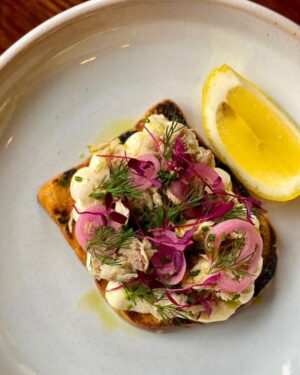 Sam Neill Instagram - I never saw a prettier breakfast , nor a yummier one . Smoked mackerel on toast with lemon cream & herbs. At Portobello 177 - (Rd) Notting Hill . Part of a great day menu 8am to 3pm - eg - croissant bread pudding w creme fraiche & berry sauce or even the World Famous Full English ! @portobello177 @worldfamous_ldn.  Full disclosure - thay are all my delightful family!