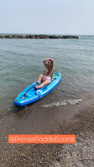 Sammi Barber Instagram - Check out my first ever #paddleboard experience, thanks to @premierpaddleboards for partnering this season 🤍🌊 
Code: SammiBarber25 for $25 off! (Link in bio)

Let me know if you have any name suggestions for this beauty! 
As mentioned in the reel we went with the “Premier Oasis 10’6 Paddle Board with Premium Accessory Kit”. It truly has everything you need! 
Size: 10’6 long, 30” wide, and 6” high (thick)
Weight capacity: 300 lbs
Board weight: 20 lbs

Included Premier Accessories:
3 piece adjustable Aircraft-grade aluminum paddle. Yes it floats!
Ankle leash
Carrying case backpack with shoulder and waist straps
2 stage high pressure hand pump (pump up your board twice as fast)!
Removable center fin
Repair kit

🌊🌞🌊 #beach #sup #paddleboard #summervibes #flamingoboard #paddle #waterfun #canadiansummer #torontobeaches