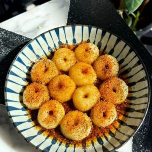Saransh Goila Instagram - 5 ingredients only to make these podi potato button noodles. Trust me when I say this - your weekend will be extra comforting when you eat these. Don't worry about that extra pour of ghee. After the tadka just preserve the ghee and use it elsewhere. As these potato noodles are boiled they don't soak in much - so just coat or dip and eat and they're oh so delishaaas. Will you try this desi version of viral potato noods?
.
Podi Potato Button Noodles

300g Potato, boiled 
1/2 tsp Garlic powder 
1 tsp Crushed black pepper
Salt to taste
80g Tapioca starch or Potato starch 
Mix well 
Shape into bite sized pieces 
Use a chopstick to make a dent 
Look at that 🤌🏻

Add salt to boiling water 
Drop them carefully into the water 
& boil them for about 3 to 4 minutes 
Or till they float on top 
Strain them out 

Generously sprinkle podi onto the 
noodles
Pour hot ghee on the top 

Mix well 
Delishaaas 🤌🏻🤤
