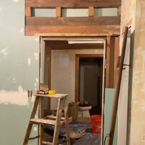 Sasha Frolova Instagram - Progress report:
The most daunting, challenging room in the house is by far the kitchen. Simultaneously the hearth of the home and a huge priority to make a safe, cozy room for creating, consuming and keeping company. Everyone suggested we drywall over the drywall but the old drywall had a crazy joint compound texture highlighted by grease and smoke to the point where you could tell where artwork used to hang in the room. We started by ripping the drywall out with an oscillating saw and a crowbar. Mouse poop and dust showering upon us. Mind you, before we had a working shower of the water variety. 
In this process we found original beams behind the drop ceiling! Beams, beams, beams! So we had to take the extra time to reveal those. Once the drywall was all removed we fogged the room with mold spray, filled any holes with mouse spray foam (found in the garden section at Home Depot), new rock wool insulation, and mold resistant drywall. We wanted to highlight some of the beautiful wood work we found in the walls when we demoed them so we made these three little cubbies that were already ‘framed out’. 

As for the appliances, even though I tried desperately to keep the refrigerator to spite everyone, even washed it in the stream before we had running water, it had to go. Hot tip: don’t pay someone to get rid of your fridge! Refrigerators are not allowed at dumps because of the coolant. Find a metal recycling plant and they will buy your fridge for a few bucks based on the weight. Dishwasher was broken. The oven was and is so grease caked but it’s Viking and I’m still trying to save her. My first attempt at cleaning the mysterious 1.5 inch thick goop in the burner trays I found a dead mouse stuck and nearly had to bring a feinting couch over for myself while I scooped it out with my five in one tool. 

The walls and my cracked fingers are now getting a layer of hydrated lime and sand at a 1:3 ratio and then a finishing coat at 1:1. We also framed out a couple of decorative cubbies using an oscillating saw, cut up pieces of paint mixing sticks, joint compound and scrap drywall. 

Onwards and upwards, 2024 ✨thank you for your love and patience @erinwolfmommsen