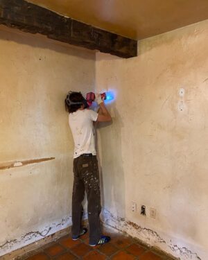 Sasha Frolova Instagram - Progress report:
The most daunting, challenging room in the house is by far the kitchen. Simultaneously the hearth of the home and a huge priority to make a safe, cozy room for creating, consuming and keeping company. Everyone suggested we drywall over the drywall but the old drywall had a crazy joint compound texture highlighted by grease and smoke to the point where you could tell where artwork used to hang in the room. We started by ripping the drywall out with an oscillating saw and a crowbar. Mouse poop and dust showering upon us. Mind you, before we had a working shower of the water variety. 
In this process we found original beams behind the drop ceiling! Beams, beams, beams! So we had to take the extra time to reveal those. Once the drywall was all removed we fogged the room with mold spray, filled any holes with mouse spray foam (found in the garden section at Home Depot), new rock wool insulation, and mold resistant drywall. We wanted to highlight some of the beautiful wood work we found in the walls when we demoed them so we made these three little cubbies that were already ‘framed out’. 

As for the appliances, even though I tried desperately to keep the refrigerator to spite everyone, even washed it in the stream before we had running water, it had to go. Hot tip: don’t pay someone to get rid of your fridge! Refrigerators are not allowed at dumps because of the coolant. Find a metal recycling plant and they will buy your fridge for a few bucks based on the weight. Dishwasher was broken. The oven was and is so grease caked but it’s Viking and I’m still trying to save her. My first attempt at cleaning the mysterious 1.5 inch thick goop in the burner trays I found a dead mouse stuck and nearly had to bring a feinting couch over for myself while I scooped it out with my five in one tool. 

The walls and my cracked fingers are now getting a layer of hydrated lime and sand at a 1:3 ratio and then a finishing coat at 1:1. We also framed out a couple of decorative cubbies using an oscillating saw, cut up pieces of paint mixing sticks, joint compound and scrap drywall. 

Onwards and upwards, 2024 ✨thank you for your love and patience @erinwolfmommsen