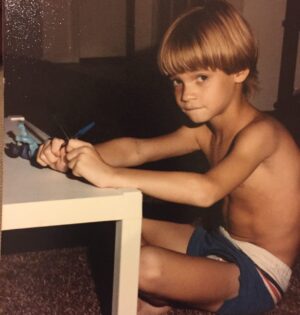 Shane West Instagram - #tbt ….to thick bowl haircuts, sexy carpets, playing with 2 pens for some reason, and of course Skeletor 🤷‍♂️ 💀 
Ah, the simple things in life…. 

Oh and being tan. I can be tan!! Here’s proof! 😅

Fun fact :  I still wear this swimsuit. 

#throwbackthursday #80s #summer #pooldays