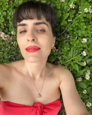 Sophia Wallace Instagram - Sophia Wallace, @sophiawallaceartist artist, and 2021 CRAVE Foundation grant recipient just released the "Unconquerable" necklace collection for preorder. The collection includes rose, yellow & white gold in solid 14k gold, with and without gemstones. ⁠
⁠
Sophia is wearing a gemstone prototype in rose gold with a deep aqua sapphire. "Unconquerable" orders will ship in September. Pre-order here: http://yescliteracy.com⁠
⁠
Artist statement:⁠
⁠
My whole body is precious and belongs to me alone. I am not ashamed, I am grateful. My body allows me to feel, to move, to help, to sense, to take action. I was taught to feel ashamed but that shame does not belong to me. I release it. I meet my whole self with humility and awe. This body is changing and aging. It has given me so much that I was too immature to appreciate until I faced my own mortality and that of my parents, who were always so strong and healthy. I will do my best to take care of my body, knowing that my mind, soul and physical self are indivisible. I reclaim all the denied parts of myself. I bring us all home.⁠
⁠
Sophia Wallace is a queer, feminist artist best known for establishing an iconography of the clitoridian. For eleven years, Wallace has sculpted, sketched, pasted, inflated and spoken this subject into indelible presence. Artwork by artwork, she counters a suspicious absence in art history, centering clitoridian subjectivity in a world that venerates the phallic. Wallace is exhibited widely in the U.S. and internationally, including Portugal, Spain, Austria, Mexico, Italy, Nigeria, Australia and the U.K.. Her featured TED talk, A Case For Cliteracy has been viewed over 2 million times. She can be seen on BBC/Hulu’s Planet Sex with Cara Delevigne and in The Dilemma of Desire alongside CRAVE co-founder Ti Chang, the winning documentary film at SXSW in 2020.