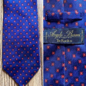 Stephen Fry Instagram - A Tie Rack edition today. Older viewers will remember how every High Street and railway station used to boast a Tie Rack store. Some were little more than booths or kiosks. Along with Sock Shop the chain exemplified a corner-turning moment in 80s and early 90s retail style and habits.

Pic 1 (swipe left) shows a standard Tie Rack tie, with a standard Tie Rack label. Fine in its way – has a pleasing mauve sheen when you turn it in the light.

Pic 2 displays a “Primavera For Tie Rack”. Was Primavera (the Italian for “spring”) an in-house design studio, I wonder? Did the extra name on the label indicate a “designer tie” with a corresponding hike in price? The word “designer” was beginning to be prepended to everything from sunglasses to boxer shorts back then.

Pic 3 shows two “Charleston Tie Rack” specimens.

Swipe left again for a “Chevalier” tie which looks to be greatly influenced by Versace (yes, doesn’t it need a damned good steam?) Pic 5 is “Angelo Bosani”. I wonder if Signor Bosani designed exclusively for Tie Rack? Certainly if you search for his work on eBay and elsewhere they all seems to be Tie Rack items.

Can we discern a distinct difference according to label? Every one of them is 100% silk and all declare themselves to be made in Italy (except the Chevalier which doesn’t reveal its origin). I would say the two Charlestons and the Primavera have a certain something in common, an almost watercolour effect perhaps, whereas the Pic 1 Tie Rack, the Chevalier and the Angelo Bosani are all individual unto themselves.

It’s of no great matter, doubtless some marketing figure decided that there should be this variation in labelling. Tie Rack has gone to retail heaven where it is kitting out the angels in good, but not great, fine but not fabulous, quality but not costly, neck wear. I wish them a blissful eternity, or as Horatio almost phrased it to the dying Hamlet, “Good night, sweet Tie Rack, and flights of angels sing thee to thy rest.”