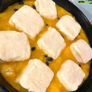 Stephen Satterfield Instagram - Late summer luxury. Transporting me to childhood. To granny’s house on whites mill. To 90s buffet lines, like shoney’s and piccadilly and sizzler and all the like I can’t quite  remember right now. Cobbler is my favorite kind of indulgence — accessible. Here’s a PSA in the spirit. 

Preheat to 400 degrees like Juvi. Remove skins from a gang of peaches,  til you can fill like 4-5Cups.  Put those peaches in a saucepan. To that you add a quarter cup: of sugar and water, plus a Tablespoon of cornstarch to thicken it up. I also added a pinch of cardamom and black pepper from my sister @sanajaverikadri of @diasporaco, making a good decision even better.  Snuck in some elderberries for the ancestors. But  there are no rules, just move as you please. 

Cook til soft, but not too soft, more like a low simmer for bout 20 min.

While that is underway, gotta slay the drop biscuits. This is not my normal biscuit recipe, but it’s the one for the occasion... 

Put a sieve over a bowl. Add 1C flour, 1.5TB sugar and baking powder, plus pinch of salt. Shake the sieve like a walnut tree at harvest until the dry mix is in a super fine form in your bowl. Now we need butter. The colder the better. A full stick. Grate it like the cheap Kraft “Colby Jack” use your fingertips to add the fat to the mixture be gentle and go until the mix is a bit pebbled. Add a 1/3 Cup of milk and bam you got biscuit dough. Now shape it into little squares. 

Back to the base. Transfer from saucepan to a cast iron and carefully plop the biscuits on top. Cook til golden brown. Eat hot with vanilla ice cream on top, y’all already know....