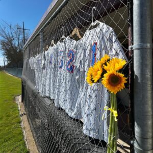 Tabitha Soren Instagram - I'm back @PomonaCollege today watching Dixie's college softball team play and retire her jersey number, 54. 🌻 I'm so grateful to the team, the coaches and the school for thinking of Dixie in all the different ways that they have - especially the sunflowers. This would be her senior season and I know she'd be playing her heart out.  I suspect I'll be crying my eyes out much of today.⁠
⁠
I received a moving email recently from a @Cal_Nuggets teammate of Dixie’s named Sophia. She is now on Willamette's softball team and she was on her way play the Pomona/Pitzer Sagehens. ⁠
⁠
"Dixie and I talked about everything from our stresses over calculus to our relationships (the love she had for Ross (which was incredible, I could tell even back then), and ultimately about our dreams to play softball in college. We became Nuggets throwing partners and went through every pre-game warm up together, chatting about life or giving each other softball-related support when we needed it. One of my favorite things about Dixie was that even on a softball field as we warmed up for a game, we could have intense conversations about politics -- she was so passionate and outspoken, and at the time I was much more unsure of myself and my opinions. I have always looked up to her for those qualities she so boldly exhibited. ⁠
⁠
Our team is filling our locker room with sunflowers this week, wearing either sunflowers or yellow ribbons in our hair, and I will be bringing a picture of her to keep in my locker. I am also meeting with Pomona Pitzer Coach JoAnne before we play to share memories of Dixie and to see her jersey in person."⁠ 

#gratefulforthekindnessintheworld
#actofremembrance 
⁠