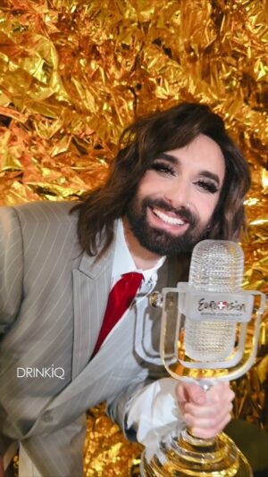 Thomas Neuwirth Instagram - #Ad @conchitawurst is back, teaming up with @baileysofficial for the second year as the official Baileys @eurovision Watch Party Host!
 
And guess what, we’re taking a step to make the Eurovision Song Contest more accessible, by providing delicious descriptions for the visually impaired community – trust me, you’re in for a treat 😊
#Baileys #DeliciousDescriptions #Eurovision

[Video Description] Announcing the Baileys Party host for Eurovision, Conchita! Against a shimmering golden background, Conchita introduces herself as the Baileys Watch Party host. She begins to describe herself – she has brunette wavy hair, a perfectly trimmed beard and stands next to a black bottle of Baileys. She describes her outfit - an oversized striped grey suit, with a deep red tie, and white laced knee-high boots - she is serving looks! Conchita announces more deliciously inclusive content to come!