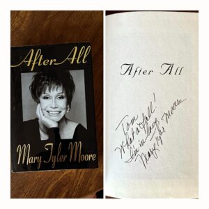 Tom Bergeron Instagram - Spring Cleaning Update: I found THIS treasure buried under some other books 🤦🏻 When Mary Tyler Moore was a guest on fX’s “Breakfast Time,” I did a “Rob Petrie Roll” over an ottoman (the classic pratfall from @official_dick_van_dyke). I didn’t think I nailed it, but this is how she signed her book to me before she left. 🥰