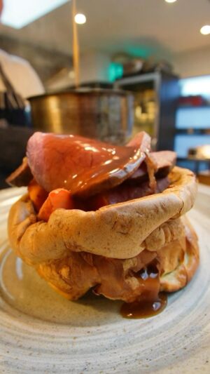 Tom Kerridge Instagram - Feast your eyes on the @thebutcherstapandgrill roast dinner, available at Marlow and Chelsea locations on Sundays. Choose from Pork or Beef, balanced on top of a supersized Yorkshire Pudding, crammed with Stuffing, Creamed Spinach, Carrots and Roast Potatoes. Topped with a generous helping of gravy…yum 🤤

#roastdinner #roastbeef #roastpork #butcherstapandgrill