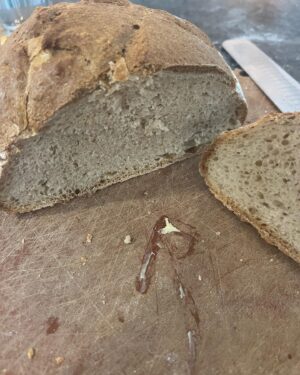 Travis McElroy Instagram - This is a sourdough beer bread using a vanilla porter. It also has a “beer paste” (vanilla porter spelt flour) added to top just before baking to give a crunchy top. Recipe from a Paul Hollywood book.