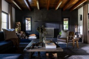 Veronica Valencia Instagram - Something that is not going away in 2024 is a rich warm palette. 🤎 Whether it be this combo of warm black and chocolate, or even deep hues like red, blue and green. I’ve always loved how dark moody spaces make you feel, and happy to see homeowners are still resonating with them. 

Also, swipe to see the BEFORE. 🕊️ I want to start sharing more of the before and afters of my projects, because they always blow my mind. For this space, we took a creamy yellow family room and transformed it into this magical beauty. This design was solely centered around a love for nature and family memories sitting around a fire at a cabin. We played off of the existing slate floor and wood ceiling, and kept it simple by adding different textures and finishes, from the fireplace material, paint finishes, drapery and even accessories. The common thread was keeping these design elements all in the same hues of chocolate and black. 
@veronicavalenciahome 

Veronica Valencia Home, 2023